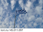 National flag of  Greece (blue and white). Flags blowing on the wind in a sunny summer day. Flags against blue sky background. (2019 год). Стоковое фото, фотограф YuryKara / Фотобанк Лори