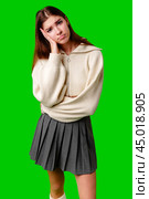 Young Woman Looking Bored and Disinterested Against Green Background. Стоковое фото, фотограф Сергей Толмачёв / Фотобанк Лори
