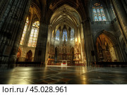 Sunlight illuminating transept of gothic cathedral through stained glass windows. Стоковое AI-изображение, AI-художник Иван Рябоконь / Фотобанк Лори