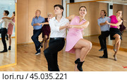 Young couple practicing vigorous lindy hop in choreography class. Стоковое фото, фотограф Яков Филимонов / Фотобанк Лори