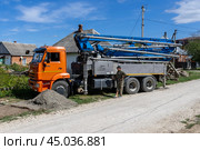 Adygea, Russia - September 7, 2024: concrete pump on KAMAZ chassis in rural areas. Редакционное фото, фотограф Андрей С / Фотобанк Лори