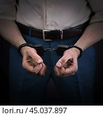 Concept of economic crime. Businessman in handcuffs and with dirty hands. Стоковое фото, фотограф Дмитрий Кобзев / Фотобанк Лори