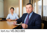 Woman boss firing upset adult male employee. Стоковое фото, фотограф Яков Филимонов / Фотобанк Лори