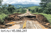 Damaged road collapsing after landslide at sunset. Стоковое AI-изображение, AI-художник Юрий Поздников / Фотобанк Лори