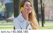 Calling by Phone. Happy beautiful blonde model talking on cell phone. Стоковое видео, видеограф Андрей Аркуша / Фотобанк Лори
