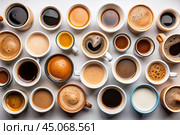Lots of mugs of different coffee and coffee drinks on a white table. Top view, flat lay. Стоковое AI-изображение, AI-художник Photojuli / Фотобанк Лори