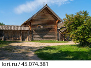 View of an ancient log building on the territory of the Pushkin village in Bugrovo of the Pushkin Museum-Reserve on a sunny summer day, Pushkinskiye Gory, Pskov region, Russia. Редакционное фото, фотограф Ula Ulachka / Фотобанк Лори