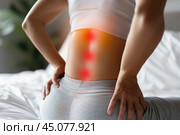 Lumbar intervertebral spine hernia, woman with back pain at home, spinal disc disease, health problems concept. Стоковое AI-изображение, AI-художник Станислав Тарко / Фотобанк Лори