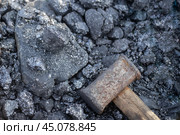 Large sledgehammer for breaking large pieces of coal, mineral fuel for home stoves and boilers. Heating country houses. Стоковое фото, фотограф Коханова Наталья / Фотобанк Лори
