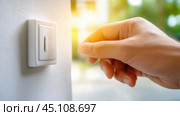 Hand adjusting a dimmer switch on a sunny day, creating a cozy atmosphere indoors, AI. Стоковое AI-изображение, AI-художник Сергей Старуш / Фотобанк Лори