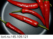 Красный острый перец на сковородке, острая приправа для приготовления еды. вкусовые добавки, овощ. фон для оформления. Стоковое фото, фотограф Алёна Мостович / Фотобанк Лори