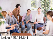 Female students discussing with groupmates sitting in circle in auditorium during classes room. Стоковое фото, фотограф Яков Филимонов / Фотобанк Лори