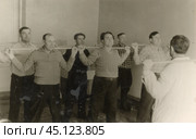 Мужчины занимаются лечебной физкультурой. 1950-е годы. Стоковое фото, фотограф Retro / Фотобанк Лори