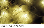 Transparent skeletons glowing yellow, close-up. Transform your space with a whimsical garland featuring glowing skeleton skulls and bones, perfect for Halloween festivities and ambiance. Horror theme. Стоковое видео, видеограф Юлия Петровская / Фотобанк Лори