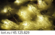 Transparent skeletons glowing yellow, close-up. Transform your space with a whimsical garland featuring glowing skeleton skulls and bones, perfect for Halloween festivities and ambiance. Horror theme. Стоковое видео, видеограф Юлия Петровская / Фотобанк Лори