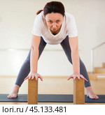 Pregnant woman is engaged in yoga. Standing Half Forward Bend or Ardha Uttanasana. Стоковое фото, фотограф Татьяна Яцевич / Фотобанк Лори