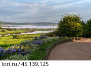 View of Lake Kuchane from the foot of the Mikhailovskoye estate of the Pushkin Museum-Reserve on a sunny summer day, Pushkinskiye Gory, Pskov Oblast, Russia. Редакционное фото, фотограф Ula Ulachka / Фотобанк Лори