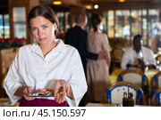 Woman waiter demonstrating her upset with small tip. Стоковое фото, фотограф Яков Филимонов / Фотобанк Лори