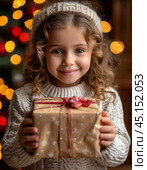 A little girl is happy with a gift, which she opens with great curiosity. The festive atmosphere of New Year and Christmas. Стоковое AI-изображение, AI-художник Сергей Елизарьев / Фотобанк Лори