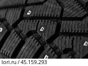 Macro photo of brand new studded car tire with metal studs. Стоковое фото, фотограф EugeneSergeev / Фотобанк Лори