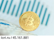Golden bitcoin physical coin symbol on keyboard. Стоковое фото, фотограф Сергей Толмачёв / Фотобанк Лори