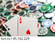 Cards and chips for poker on green table. Стоковое фото, фотограф Сергей Толмачёв / Фотобанк Лори