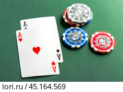 Cards and chips for poker on green table. Стоковое фото, фотограф Сергей Толмачёв / Фотобанк Лори