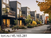 An exterior view on a row of a modular townhouse community with landscaped courtyards and communal spaces. Стоковое AI-изображение, AI-художник Михаил Строгалев / Фотобанк Лори
