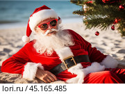 A portrait of satisfied, cheerful Santa Claus in dark glasses, lying on the sand of a tropical beach under a Christmas tree. Стоковое AI-изображение, AI-художник Михаил Строгалев / Фотобанк Лори