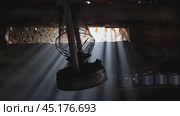 A wooden dugout in which a kerosene lamp burns. Light from the window penetrates into the room. Стоковое видео, видеограф Александр Кузовков / Фотобанк Лори