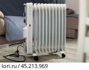 Electric oil heater on floor in room. Стоковое фото, фотограф Яков Филимонов / Фотобанк Лори