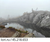 Misty morning at Volosyanaya mountain with serene water reflections in Kola Peninsula, Kandalaksha. Стоковое фото, фотограф Александра Селина / Фотобанк Лори