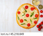 hot homemade Italian pizza margherita with mozzarella and tomatoes. Стоковое фото, фотограф Natalia Gdovskaia / Фотобанк Лори