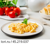 Scrambled eggs, Omelette. Breakfast with pan-fried eggs. Стоковое фото, фотограф Natalia Gdovskaia / Фотобанк Лори