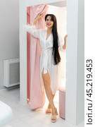 Young female is enjoying her purchases in underwear shop. Beautiful woman in the fitting room of a lingerie store. Shopping concept. Стоковое фото, фотограф Ирина Михайличенко / Фотобанк Лори