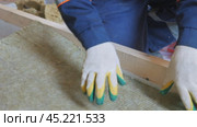 Insulation of a frame house with mineral wool. Cutting, fitting, laying insulation. Construction works. Стоковое видео, видеограф Константин Мерцалов / Фотобанк Лори