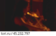 Close-up of hands playing violin. Blurred video. Warm backlighting of the stage. Two women playing violins at a concert. Стоковое видео, видеограф Воловодов Владимир / Фотобанк Лори