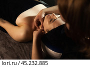 Hands of masseur female does face and neck anti-aging massage for perfect patient woman in medical spa salon. Atmospheric facial relax massage, healthy massaging, wellness concept. Copy ad text space. Стоковое фото, фотограф Aleksandr Golubev / Фотобанк Лори