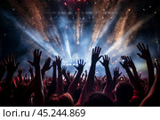 A high-energy view capturing a sea of ecstatic fans dancing and waving their hands at a rock concert, dark silhouettes of hands, highlighting the thrill of live music. Стоковое AI-изображение, AI-художник Михаил Строгалев / Фотобанк Лори