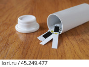 Баночка с тест-полосками для определения уровня глюкозы в крови лежат на столе. Стоковое фото, фотограф Сергей Овчинников / Фотобанк Лори