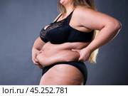 Woman with fat abdomen, overweight female stomach, stretch marks on belly closeup. Стоковое фото, фотограф Станислав Тарко / Фотобанк Лори