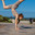 Fitness portrait young athletic woman doing gymnastics on blue sky background. Стоковое фото, фотограф Андрей Аркуша / Фотобанк Лори