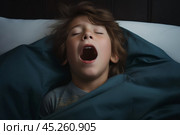 cold tones, boy in t shirt lied in bed under blanket and yawns or very emotional expression sings songs with wide opened mouth and squint eyes. Стоковое AI-изображение, AI-художник Sergey Grishin / Фотобанк Лори