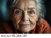 Close-up of an elderly woman with bright blue eyes and pronounced wrinkles on her face. Her gaze is calm and wise, reflecting years of experience and a life lived. The photo is taken in soft lighting, focusing on the details of her skin and eyes filled with warmth and peace. The background is darkened, allowing the focus to be on her face. This photo is perfect for themes about wisdom, age, life experience and beauty in old age. Стоковое AI-изображение, AI-художник Анна Кривицкая / Фотобанк Лори
