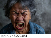 asian Elder senior woman with angry, mad, depressive and furious face expression looking for fight isolated over grey dirty background. Mature female yelling with closed eyes, annoyed and frustrated. Стоковое AI-изображение, AI-художник Sergey Grishin / Фотобанк Лори