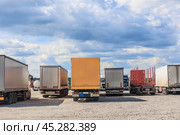 Large trucks in a suburban parking lot. Стоковое фото, фотограф Юрий Бизгаймер / Фотобанк Лори