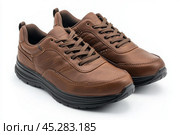 Dark brown leather lace-up running shoes with low tops, thick soles. The laces and black rubber outsole. Sporty look. Men to wear during outdoor activities, hiking. Brown shoes. Trendy Male Boots Pair. Стоковое AI-изображение, AI-художник Марина Демидюк / Фотобанк Лори