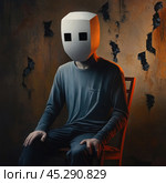 Mysterious and atmospheric scene. A man in a gray shirt sits on a chair in a room with peeling walls. On his head is a mask resembling a box with square holes cut out for the eyes. The lighting creates a contrasting effect, emphasizing the thoughtful and somewhat gloomy mood. The work is suitable for illustrating the concepts of anonymity, alienation, introversion and inner search. Стоковое AI-изображение, AI-художник Анна Кривицкая / Фотобанк Лори