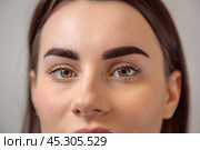 Beautician showing perfect eyebrows after microblading treatment. Стоковое фото, фотограф Юрий Поздников / Фотобанк Лори