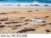 Plastic trash on the seashore. Environmental pollution. Ecological catastrophy. Стоковое фото, фотограф Коханова Наталья / Фотобанк Лори